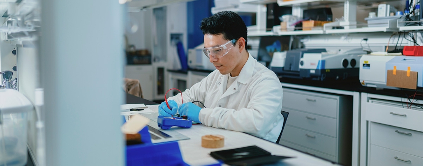 Elmer Guzman seated at lab bench