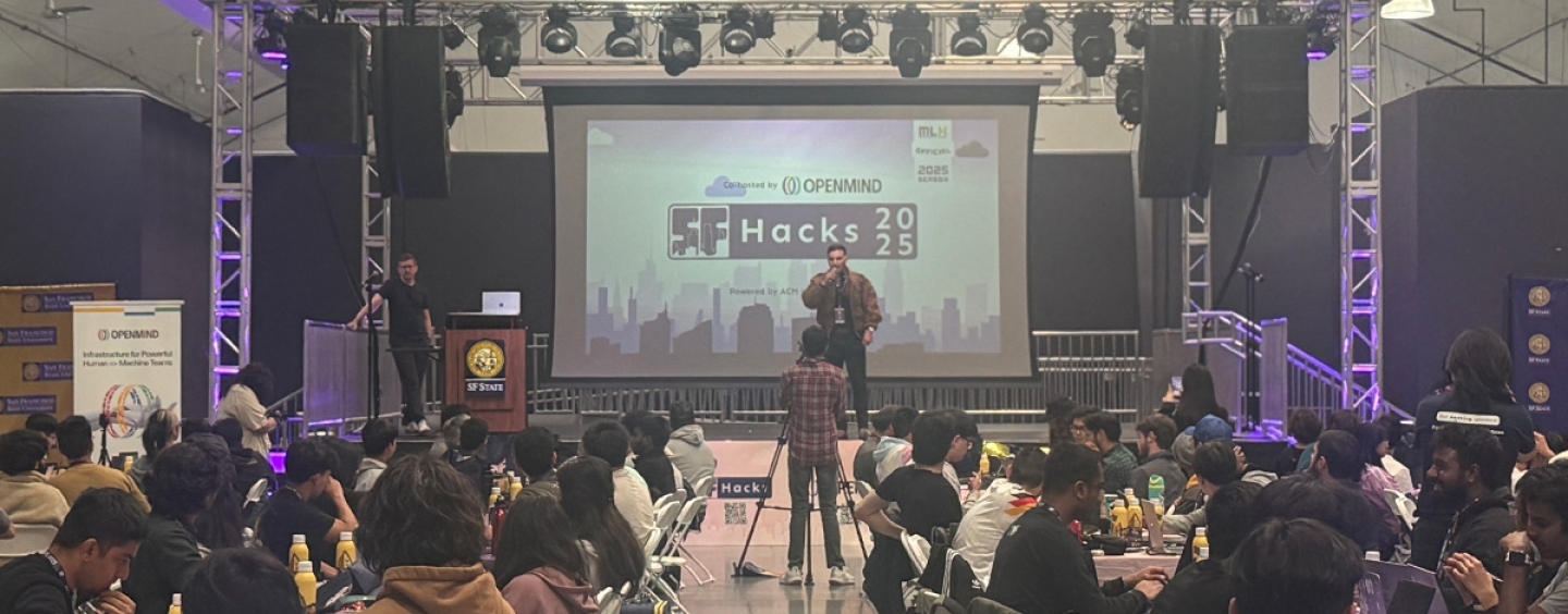 view of presenter in front of screen at SF Hacks event