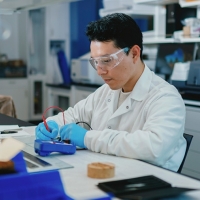 Elmer Guzman seated at lab bench